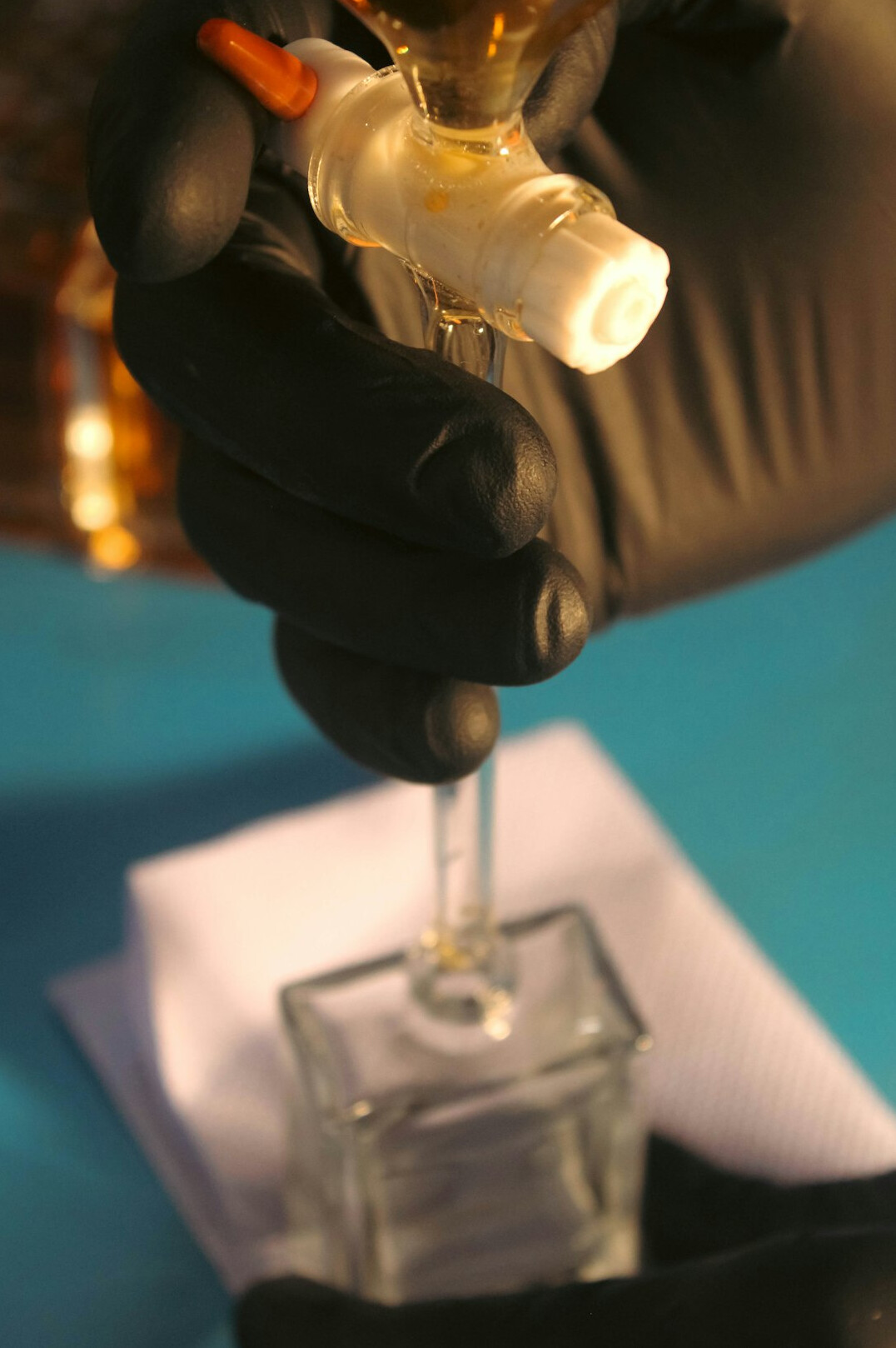 Close-up of hands testing water quality with a sample vial