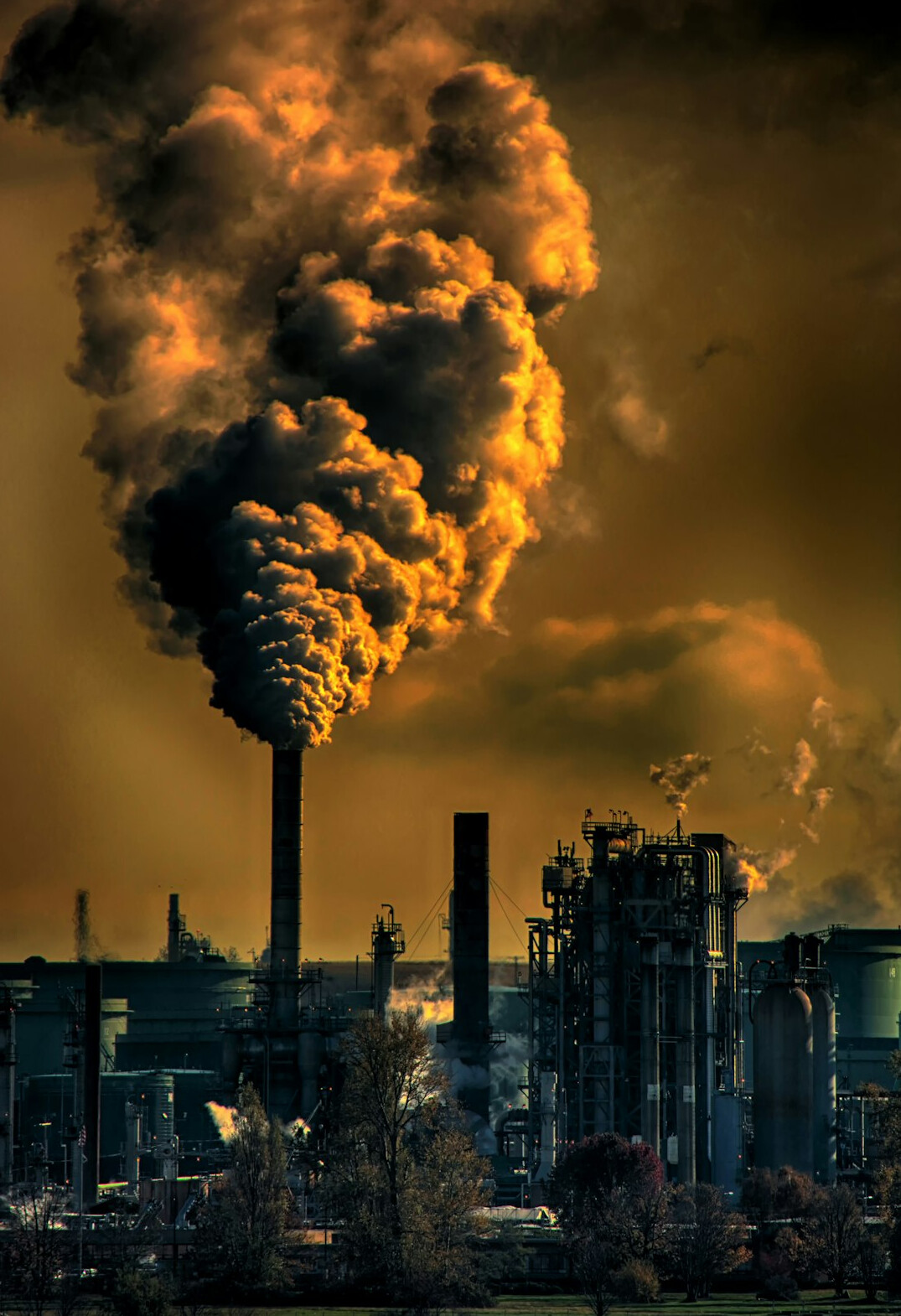 Industrial smokestacks emitting smoke into the sky